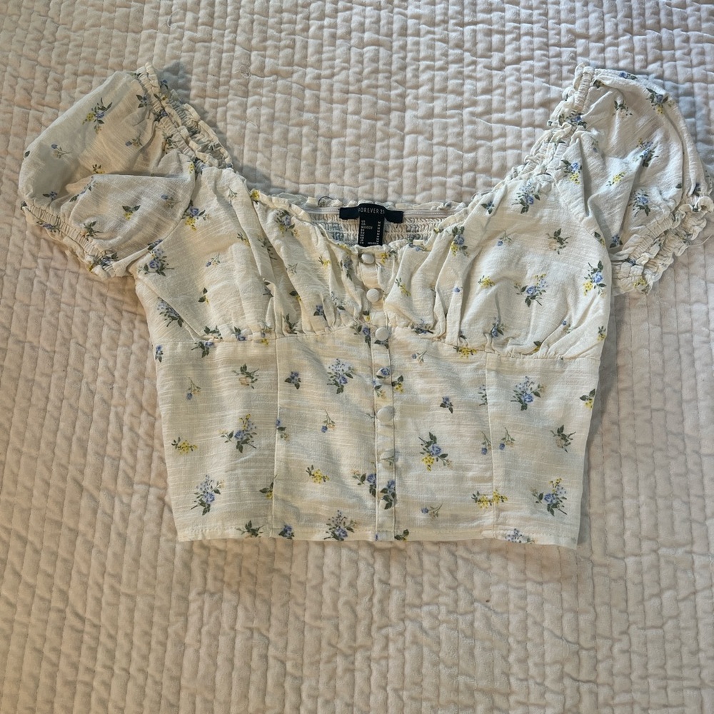 White crop top with blue and yellow floral details